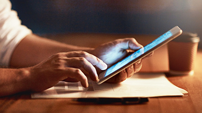 A close-up of someone's hands using a tablet 