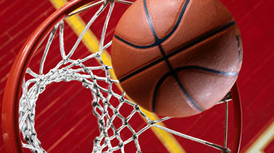 Close up shot of a basketball going through a basketball hoop