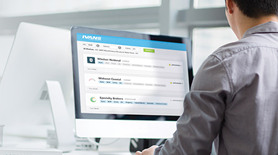 Man in business attire working on computer with IVANS on the monitor