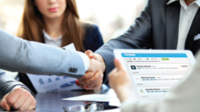 Two men in business attire shaking across the table while woman in business attire holds tablet with IVANS on screen