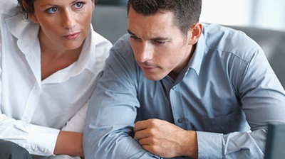 A man and a woman working closely together