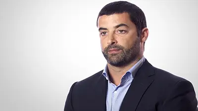 A man in a suit in an all white room
