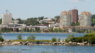 View of a waterfront with a city in the background 