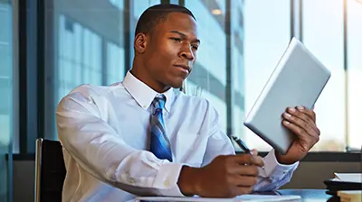 A young businessman working on his tablet