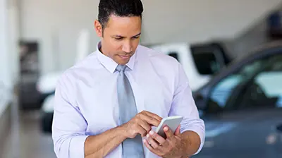 A businessman working on his smart phone