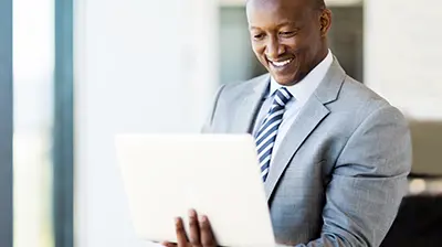 A businessman working on a tablet