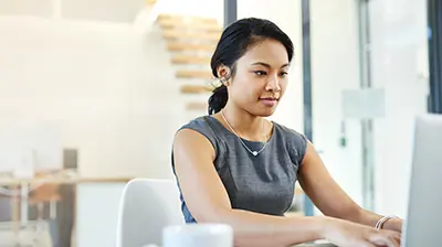 A businesswoman typing on her laptop