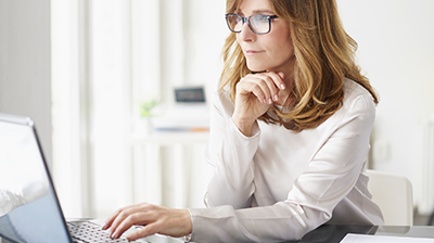 Woman working at a desk on a laptop